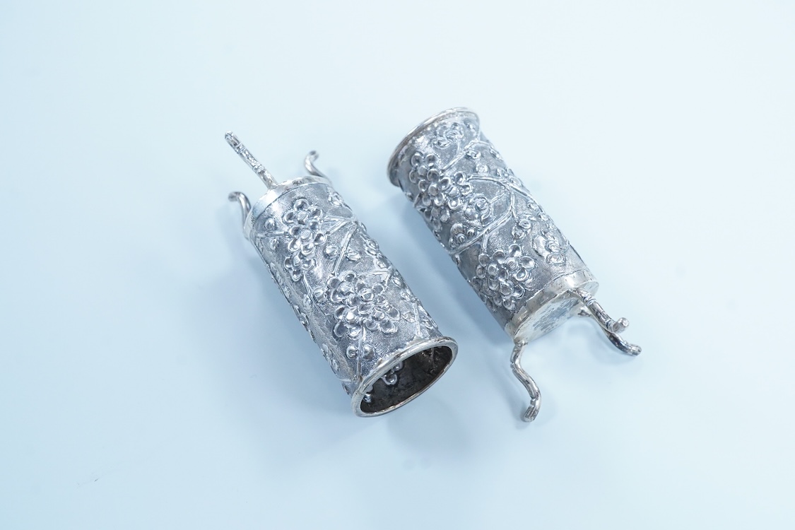 A pair of late 19th/early 20th century Chinese Export white metal cylindrical toothpick holders, by Wang Hing, Hong Kong, stamped 'WH90', on tripod feet, height 6cm.